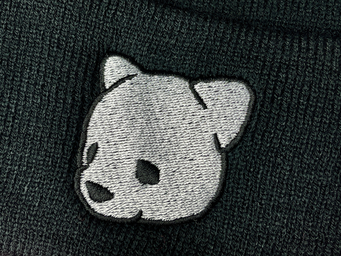 Black beanie featuring Luke Chueh's bear head. Published by Plush Art Club.