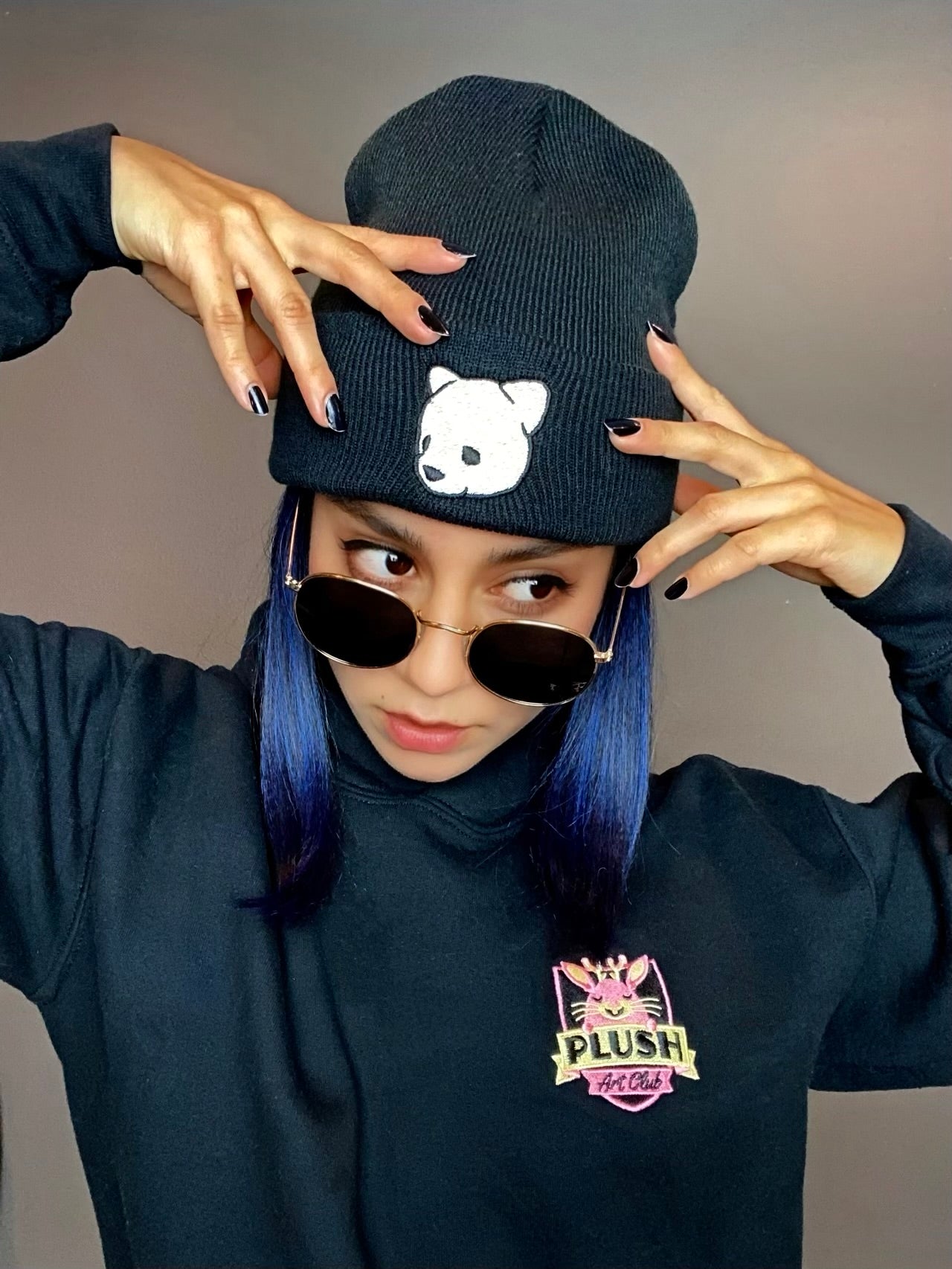 Black beanie featuring Luke Chueh's bear head. Published by Plush Art Club. Modeled by Alejandra Moreno.