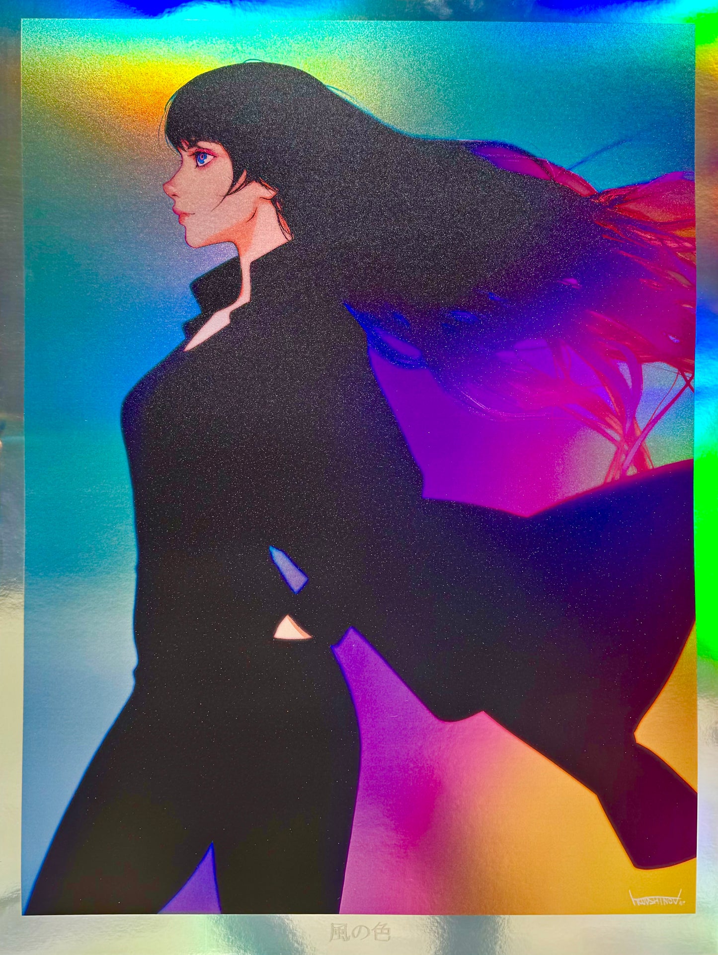 Alternate actual photo of Ilya Kuvshinov's Kaze no Iro artprint on holofoil. It depicts a girl wearing black with her coat flapping in the winds. The background features many colors and is on a holofoil stock showing some of the effects/