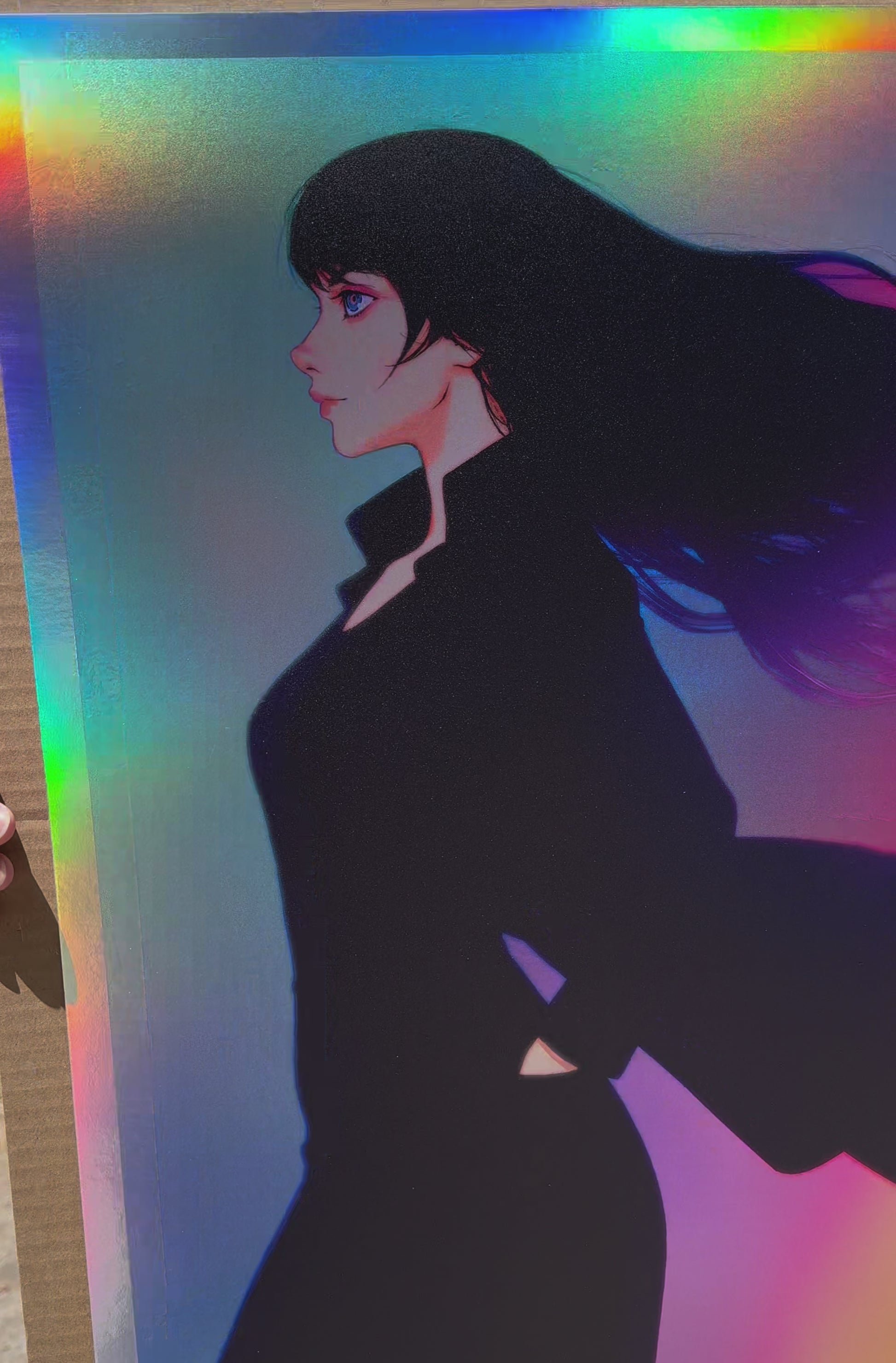 Actual video of Ilya Kuvshinov's Kaze no Iro artprint on holofoil. It depicts a girl wearing black with her coat flapping in the winds. The background features many colors and is on a holofoil stock.