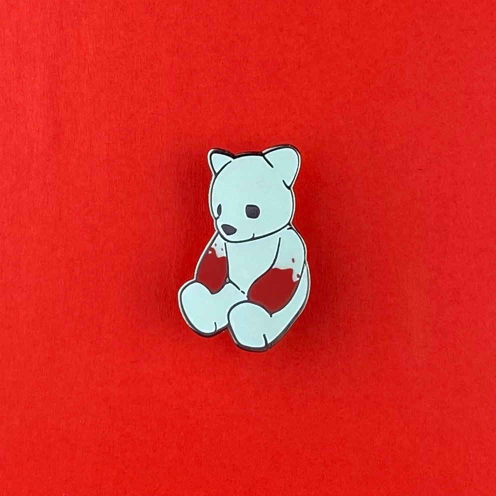 Glow-in-the-dark limited-edition enamel pin of Luke Chueh's iconic white bear as a plush doll. Published by Plush Art Club
